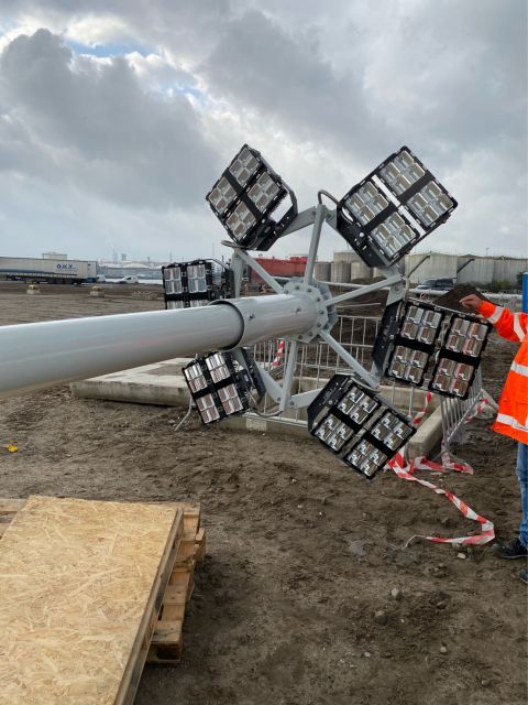 Hoogmast met LED-armaturen die op het terrein wordt gemonteerd